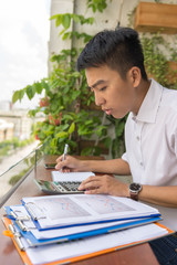 Vertical photo of accountant checking financial number on documents