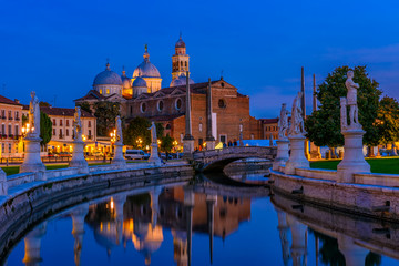 View of canal with statues on square Prato della Valle and Basilica Santa Giustina in Padova (Padua), Veneto, Italy