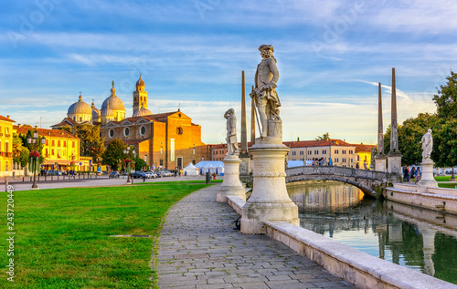 View of canal with statues on square Prato della Valle and Basilica Santa Giu...