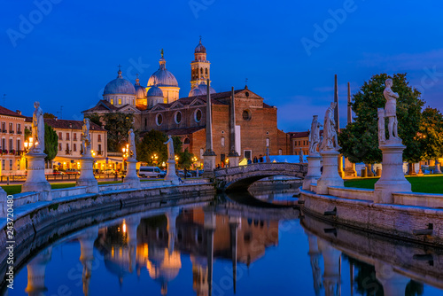 View of canal with statues on square Prato della Valle and Basilica Santa Giu...