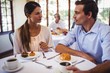 © WavebreakMediaMicro - Couple talking with each other in restaurant