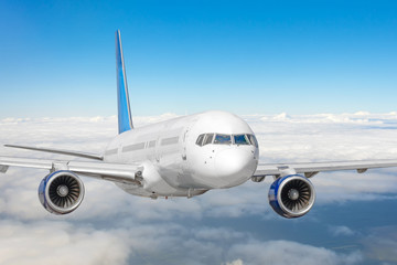 Passenger jet plane in the blue sky. Aircraft flying high through the cumulus clouds. Close up view airplane in flight