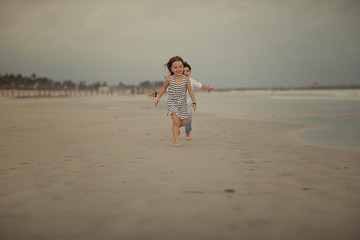 boy running after the girl on the beach