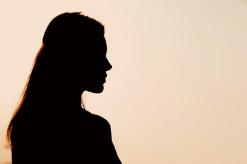 Silhouette of young beautiful woman