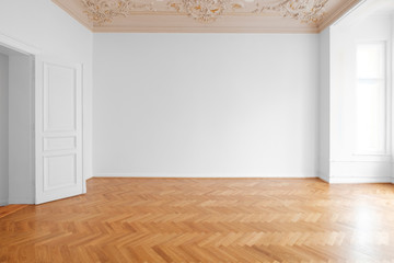 white wall background in empty apartment room , flat with wooden floor and stucco ceiling