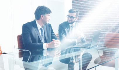 Wall Mural - Two successful employees sitting at the desk