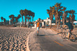 © Aerial Film Studio - Young man riding a one wheel down the Venice beach in Los Angeles, California. Beautiful summer vibes.