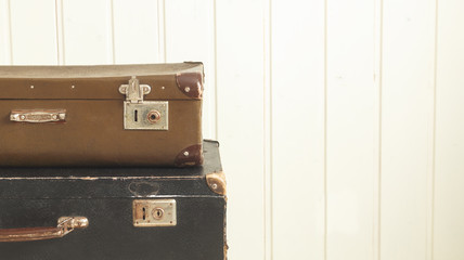 Two old retro suitcases White wooden background Vintage tinting Copy space