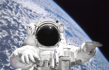 Poster - Astronaut in spacesuit close up in outer space. Planet Earth from outer space. Mixed media. Elements of this image furnished by NASA