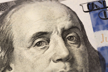 Benjamin Franklin's look on a hundred dollar bill. Benjamin Franklin portrait macro usa dollar banknote or bill.