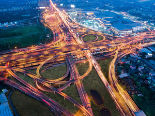 Canvas Print - Aerial view over complicate intersection road and express way in Bangkok Thailand at night with long exposure vehicle light trail. Shot by drone.
