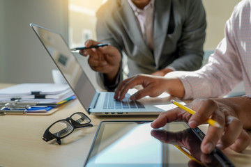 double exposure of business man hand working on laptop computer on wooden desk with social media network diagram