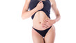 © Stavros - Woman in lingerie isolated on white background touches the belly. Menstruation and woman's health concept.