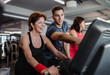 © Halfpoint - Two cheerful female seniors in gym with a young trainer doing cardio work out.