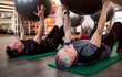 © Halfpoint - A group of cheerful seniors in gym doing exercise with fit balls.