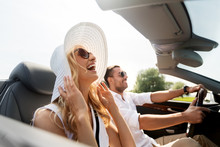 Leisure, Road Trip, Dating, Couple And People Concept - Happy Man And Woman Driving In Cabriolet Car Outdoors