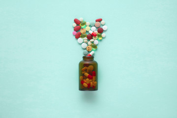 Sticker - Little glass bottle with pills spilled over a table