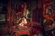© lizavetta - Girl in old carpet shop in Cappadocia