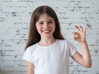 t-shirt design concept - smiling little girl in blank white t-shirt, isolated on a white background