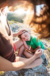 © zhukovvvlad - The tired boy lies on his mother's feet.