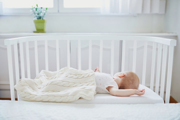 Wall Mural - Baby sleeping in co-sleeper crib attached to parents' bed