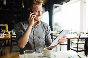 handsome smart businessman constantly busy and working