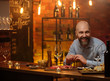 © Nejron Photo - Middle-aged man sitting behind bar counter