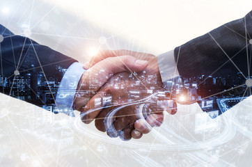 Wall Mural - business people handshaking on abstract city background with global network link connection effect diagram, digital technology, internet communication, teamwork and business partnership concept