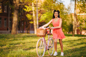 Wall Mural - Latin woman in pink dress with flowers and pink bicycle.