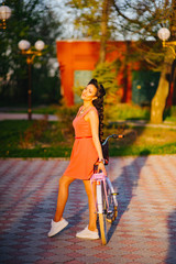 Wall Mural - Latin woman in pink dress with flowers and pink bicycle.