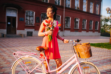 Wall Mural - Latin woman in pink dress with flowers and pink bicycle.