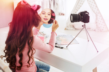 Little beautiful girl making little video presentation participating in beauty contest