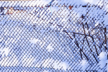 Mesh Fence After Heavy Snowfall In Sunny Weather