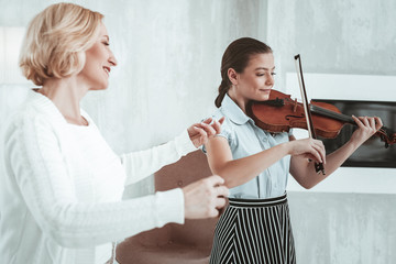 Wall Mural - Positive nice girl practicing her music skills