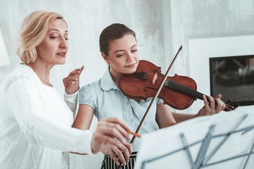 Wall Mural - Pleasant aged woman showing how to play