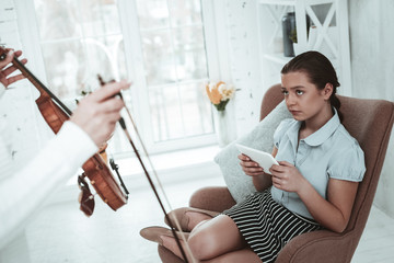 Wall Mural - Nice cheerless girl playing on her smartphone