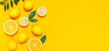 Ripe Juicy Lemons, Orange And Green Leaves On Bright Yellow Background. Lemon Fruit, Citrus Minimal Concept, Vitamin C. Creative Summer Minimalistic Background. Flat Lay, Top View, Copy Space.