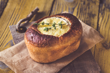 Wall Mural - Camembert bread bowl on the wooden background