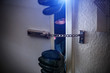 © AA+W - burglar with torch opens door of appartment