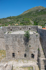 Wall Mural - Medieval stone fortress is located high in the mountains.