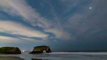 Astro Timelapse Of Starry Sky Over Arch Rock Sea Cave In Santa Cruz