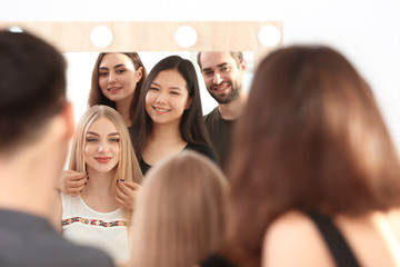 Canvas Print - Professional hairdresser and trainees working with client in salon. Apprenticeship concept