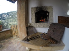 Traditional Outdoor Firewood Oven. Burning Flames In Fireplace And Tools In The Foreground