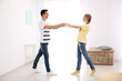 © Africa Studio - Cute young couple dancing indoors