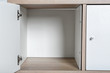 Empty wardrobe compartments, closeup view. Stylish furniture