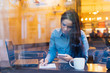 © mnelen.com - busy business woman working at a cafe, with laptop