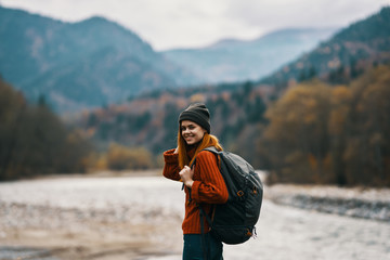 hiking in the mountains with a backpack woman nature autumn