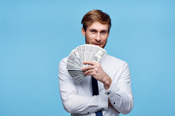 business man with a beard in the hands of money on a blue background