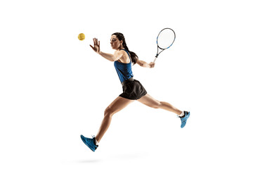 Wall Mural - Full length portrait of young woman playing tennis isolated on white background. Healthy lifestyle. The practicing, fitness, sport, exercise concept. The female model in motion or movement