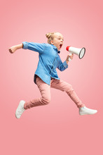 Beautiful Young Child Teen Girl Jumping With Megaphone Isolated Over Pink Background. Runnin Girl In Motion Or Movement. Human Emotions,, Facial Expressions And Advertising Concept